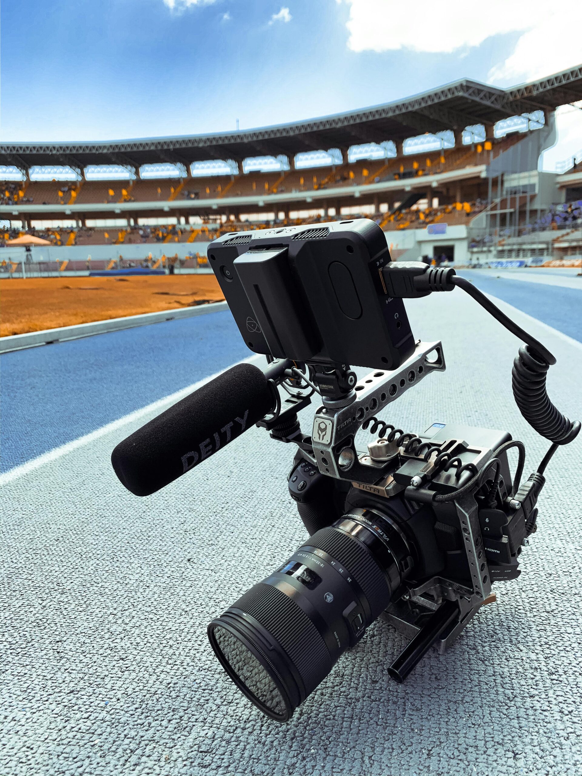 Close-up shot of a professional video camera setup at a sports stadium, capturing live events.